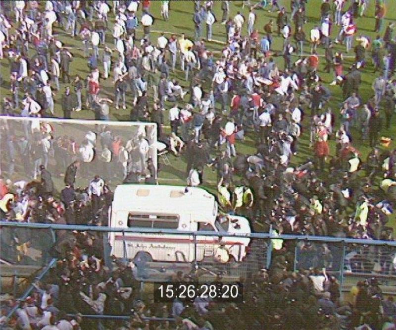 The rescue effort aided by the hole in the perimeter fence at Hillsborough Stadium at 15:26.28